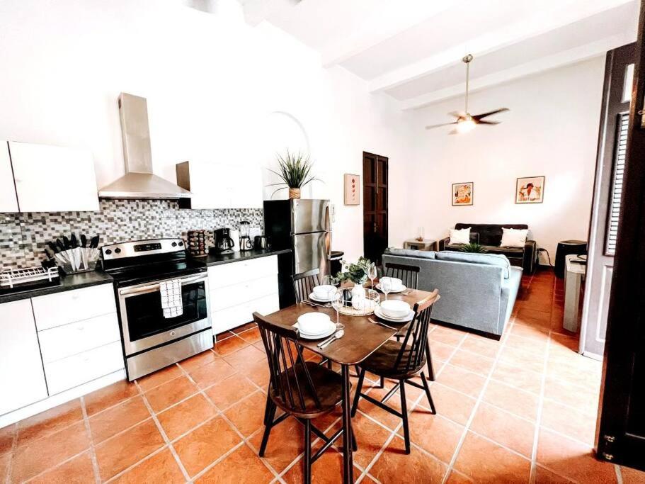 a kitchen with a table and chairs in a kitchen at 65 Fortaleza 1 - N Colonial Apt W/ Balconies & Views in San Juan