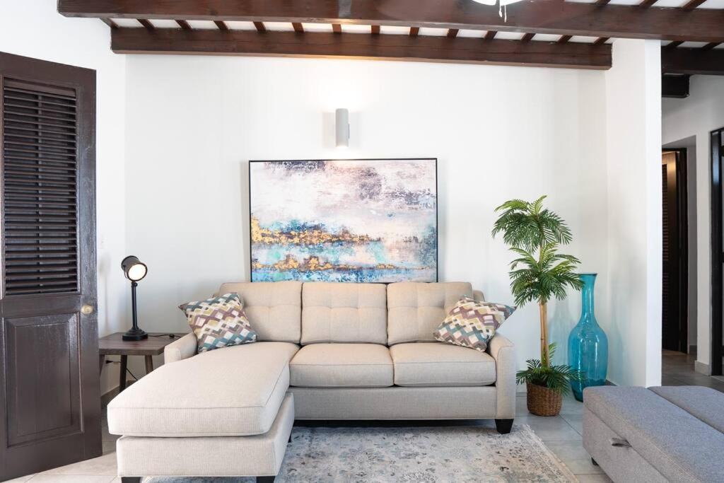 a living room with a couch and a painting at Modern PH Apt with Amazing View in Old San Juan 65 Fort 9 in San Juan