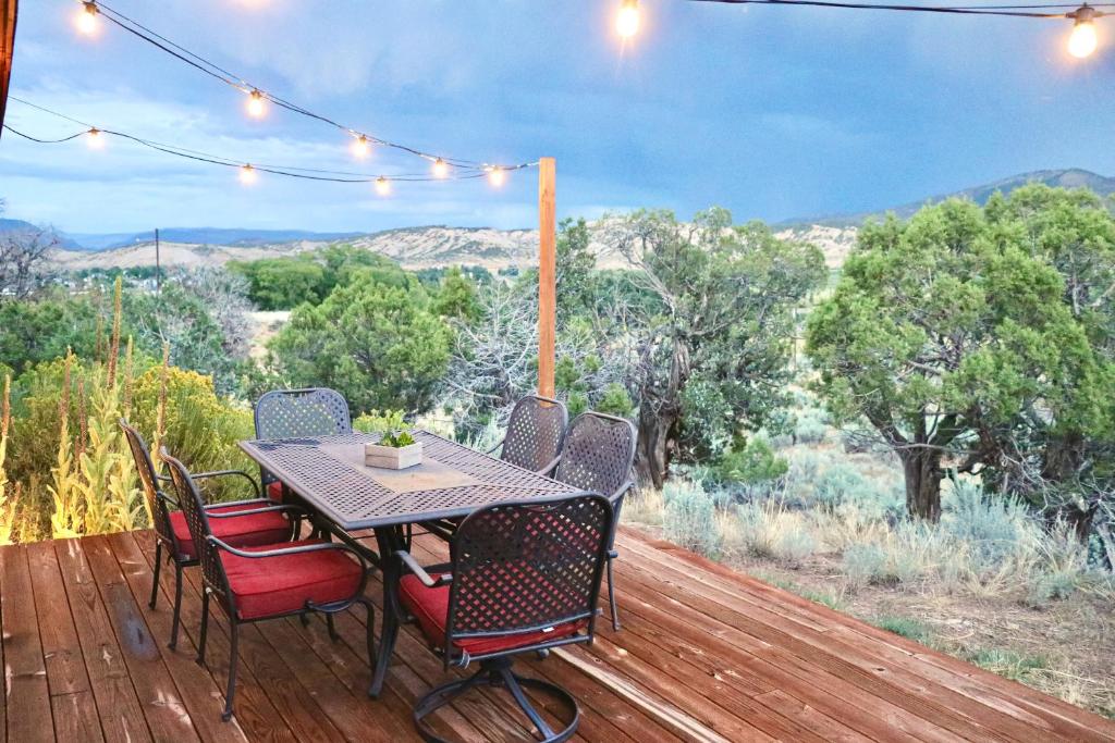a table and chairs on a deck with a view at Cottonwood Pass Retreat in Gypsum