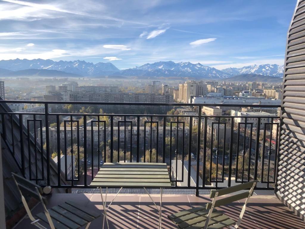 a balcony with a view of a city and mountains at Best view in city, secured 24/7 in Bishkek