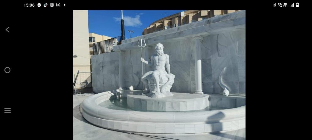 a statue of a woman sitting in a fountain at Mccoy avenida 3 in Macael