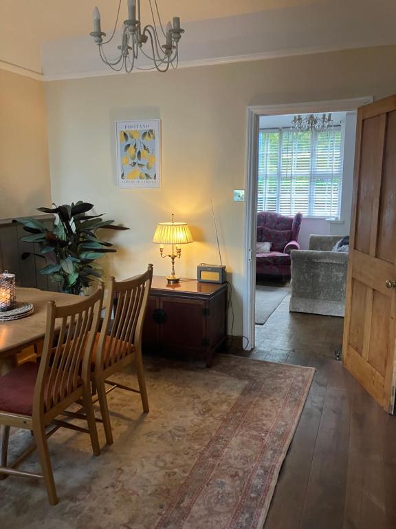 a living room with a table and a couch at Knutsford Cottage in Knutsford