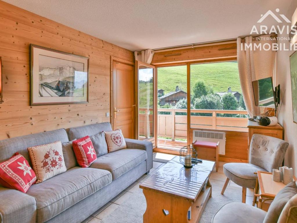 a living room with a couch and a table at Appartement Le Grand-Bornand, 4 pièces, 6 personnes - FR-1-391-144 in Le Grand-Bornand