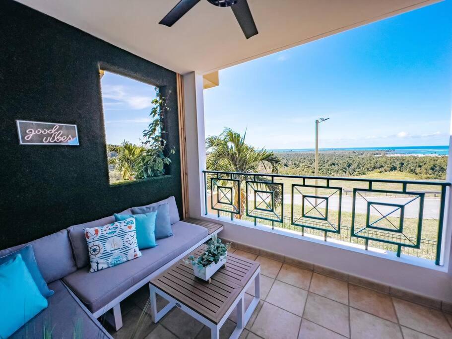 a living room with a couch and a view of the ocean at Oasis Village Spacious Apt W/ Ocean View For 9 in Rio Grande