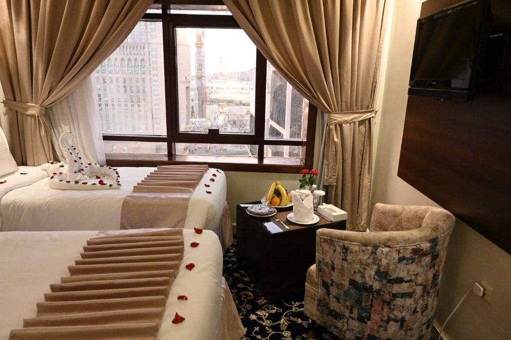 Postel nebo postele na pokoji v ubytování Maysan Al Mashaer Hotel