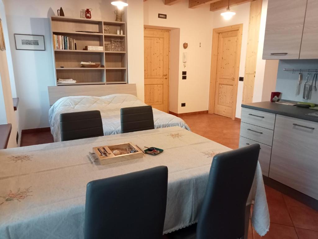 a room with a table with chairs and a kitchen at Casa Weber Levico Terme in Levico Terme