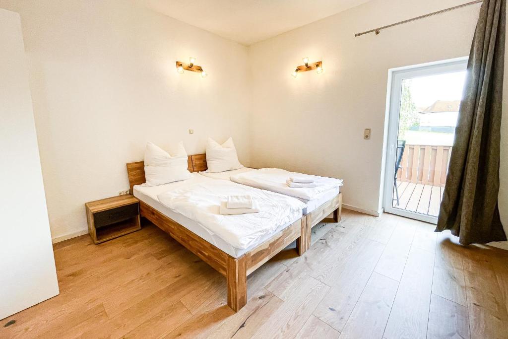 a bedroom with a bed and a large window at Good Sleep - Appartments in Irxleben