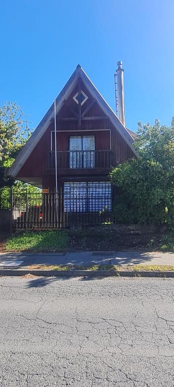 a building with a fence in front of it at cabaña in Pucón