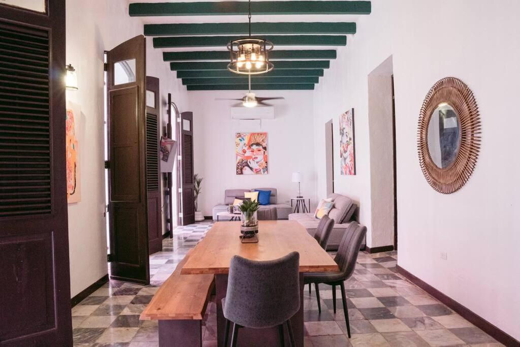 a dining room with a wooden table and chairs at Art Inspired Apt Besides Governors Mansion in OSJ - Fort Apt 11 in San Juan