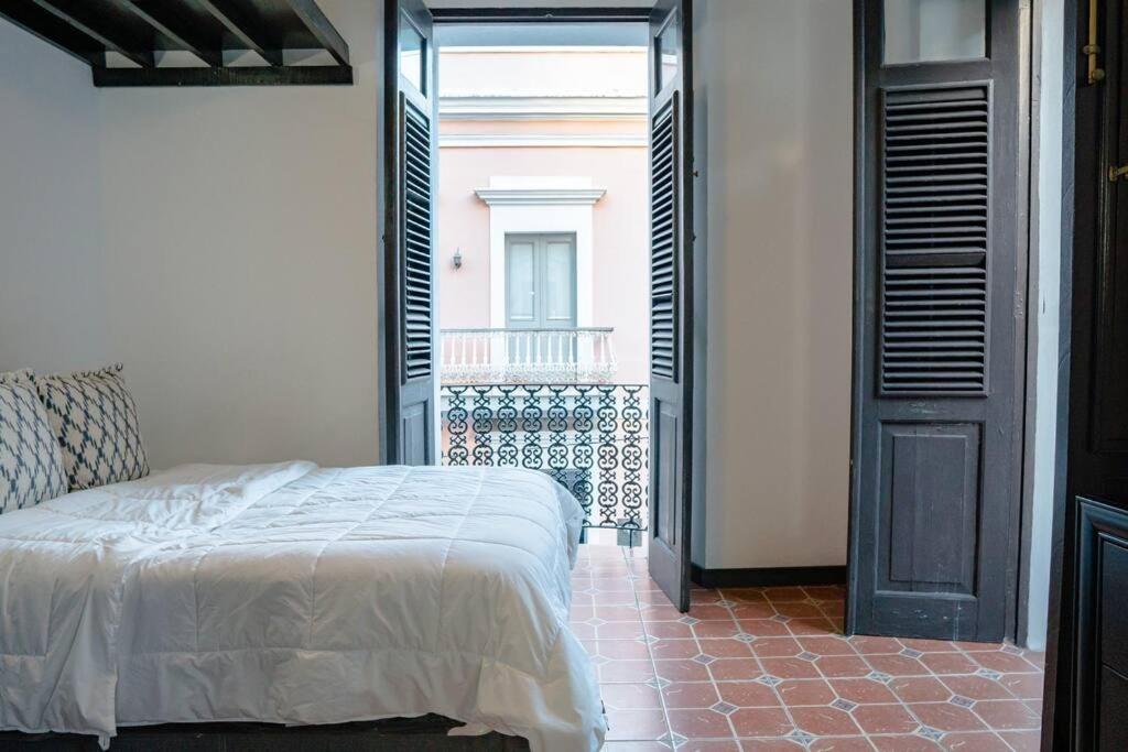 a bedroom with a bed in a room with a window at Family Getaway Apt - La Fortaleza Old San Juan - Fort Apt 4 in San Juan