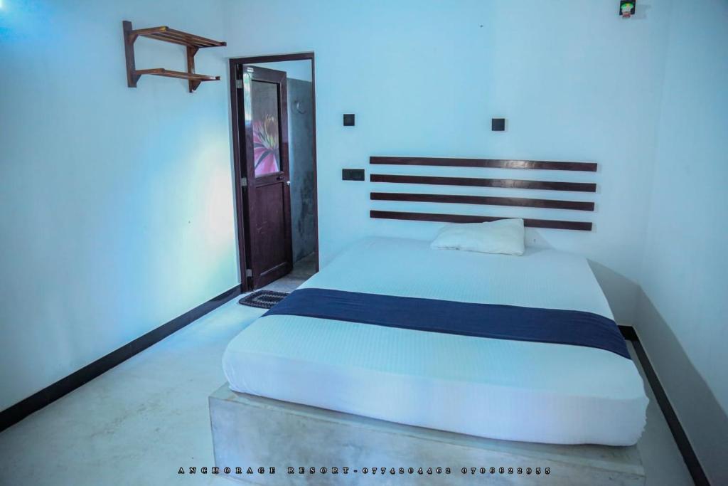 a bedroom with a large white bed in a room at The Anchorage Resort in Polonnaruwa