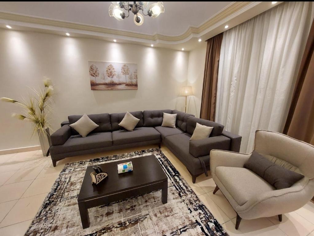 a living room with a couch and two chairs at Gazzar inn rehab9 in Cairo