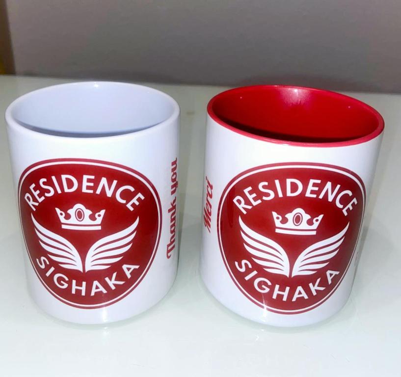 two coffee cups sitting next to each other at Residence Sighaka - Studio Meublé VIP avec WiFi, Gardien, Parking in Douala