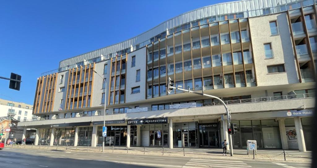 a large building on a city street with a traffic light at Garbary 100 CITY CENTER Apartment, free parking, self check-in 24h in Poznań