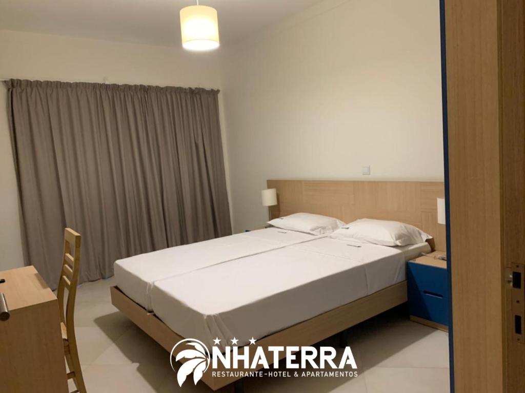 Postel nebo postele na pokoji v ubytování ApartHotel NhaTerra