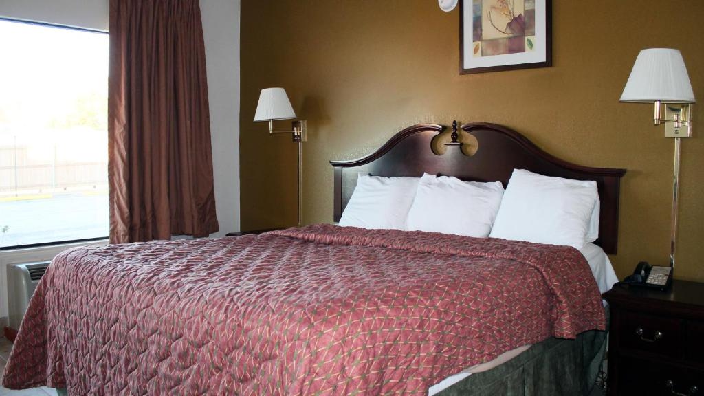 Postel nebo postele na pokoji v ubytování Royal Inn & Suites