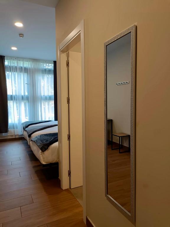 Postel nebo postele na pokoji v ubytování Apartahotel Golden Alcalá