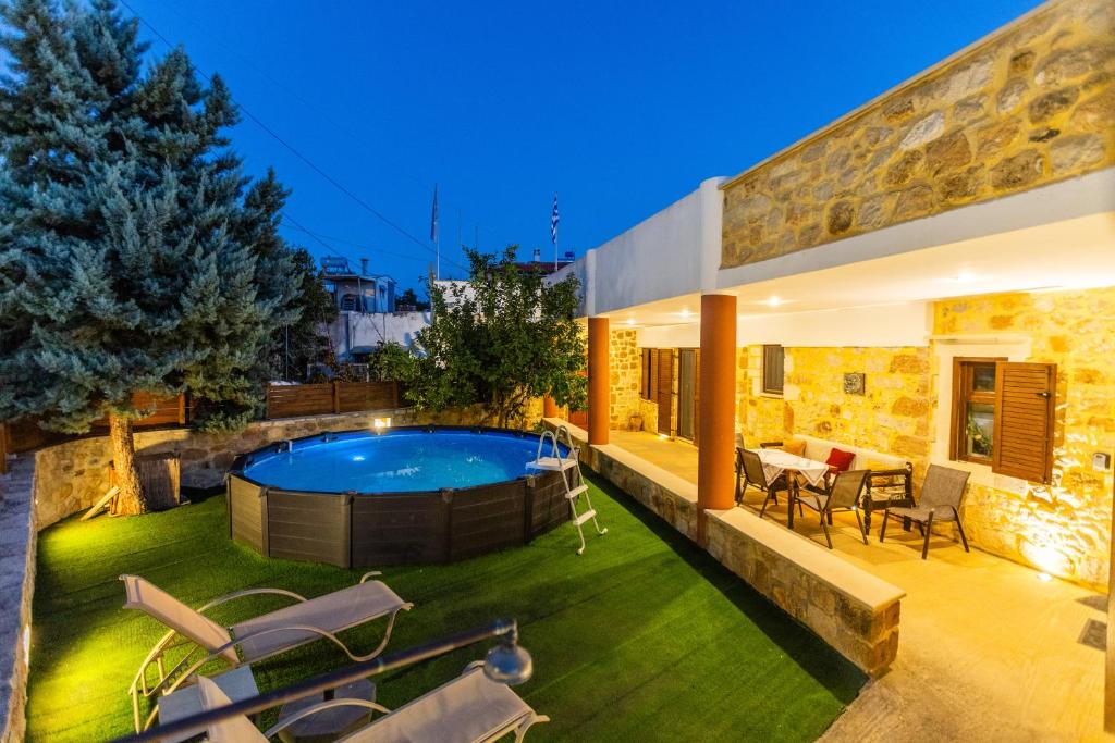 a house with a swimming pool in the yard at Stone House in Astérion