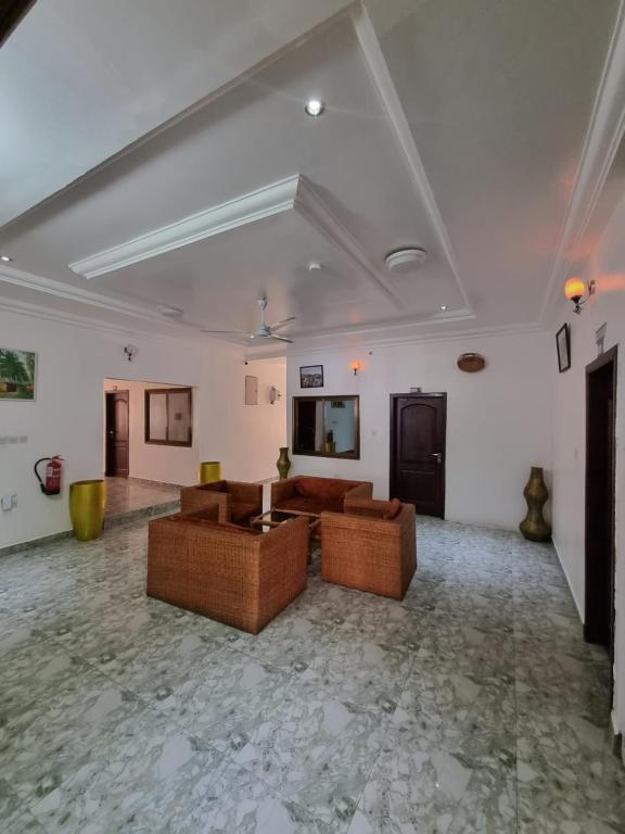 a large living room with two couches and a table at Nana's Holiday Let in Accra