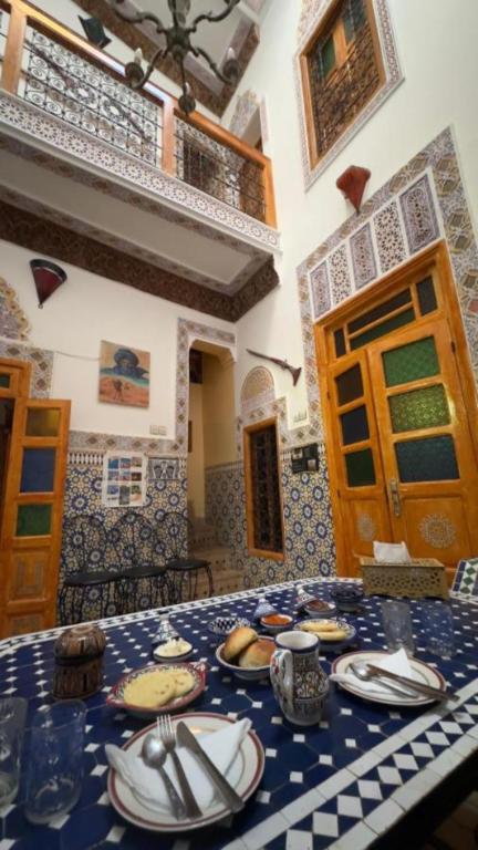 a table with plates of food on top of it at RIaD DRISSIA Panoramic in Fez