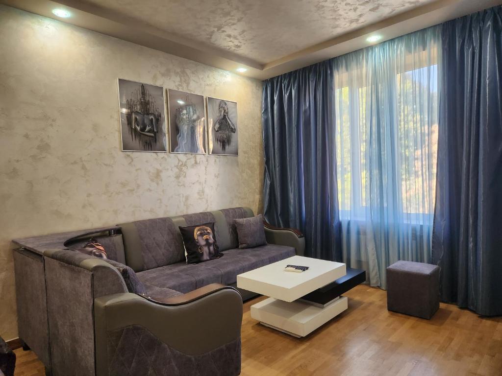 a living room with a couch and a table at Apartment at Abovyan Street in Yerevan
