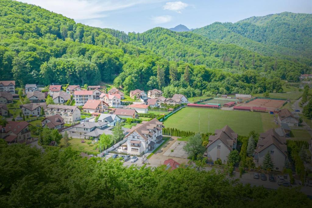 an aerial view of a village in the mountains at Safari Family Villa near Park Aventura,Lake,Zoo in Braşov