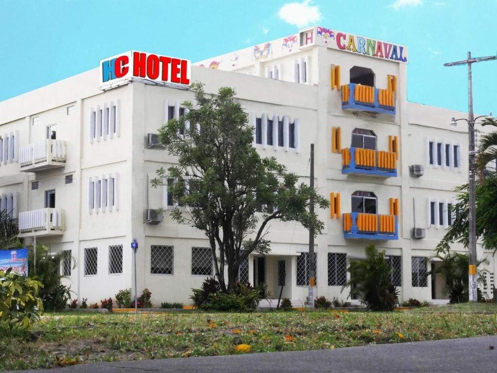 a white building with a hotel sign on it at Hotel Carnaval in La Ceiba