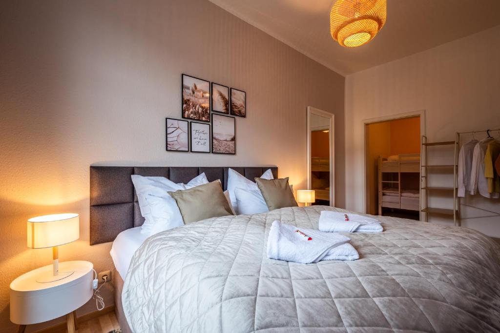 a bedroom with a large bed with two pillows on it at maremar - Ideal für Familien - Boxspringbett - Zentral - vollausgestattete Küche - Waschtrockner - Spielecke in Gera