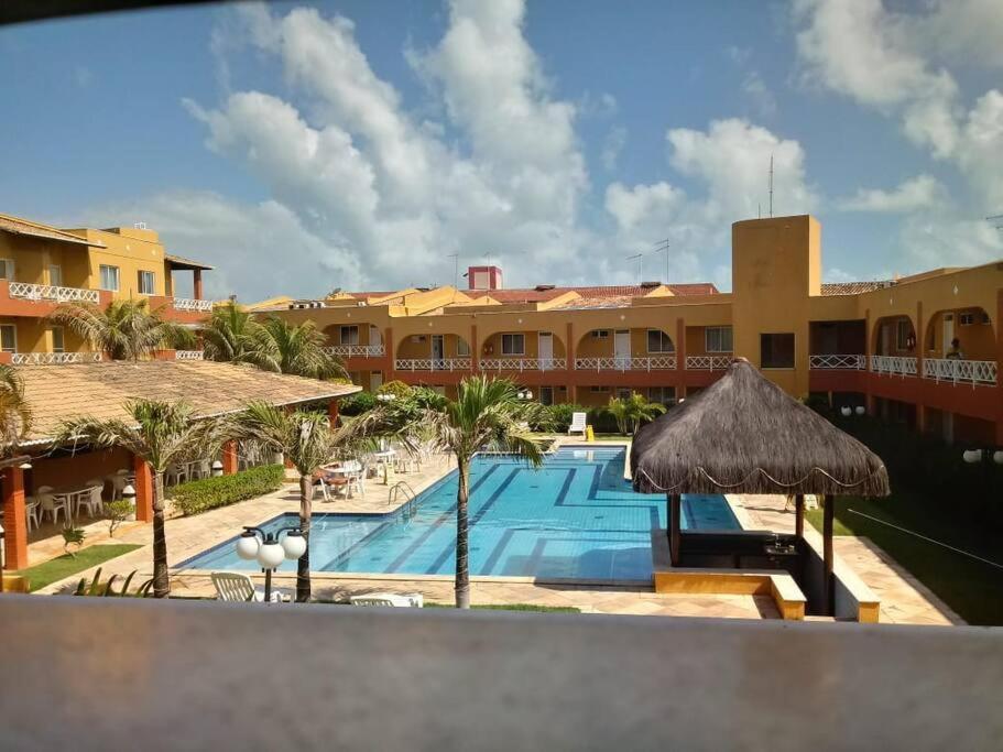 een uitzicht op een resort met een zwembad bij Apto 2quartos Buzios/Vista p/mar/Piscina in Nísia Floresta