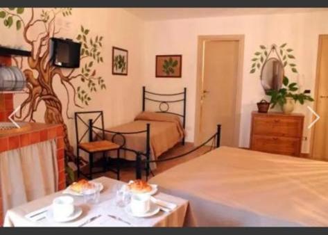 Postel nebo postele na pokoji v ubytování Antico Borgo - A due passi dalle Gole Alcantara