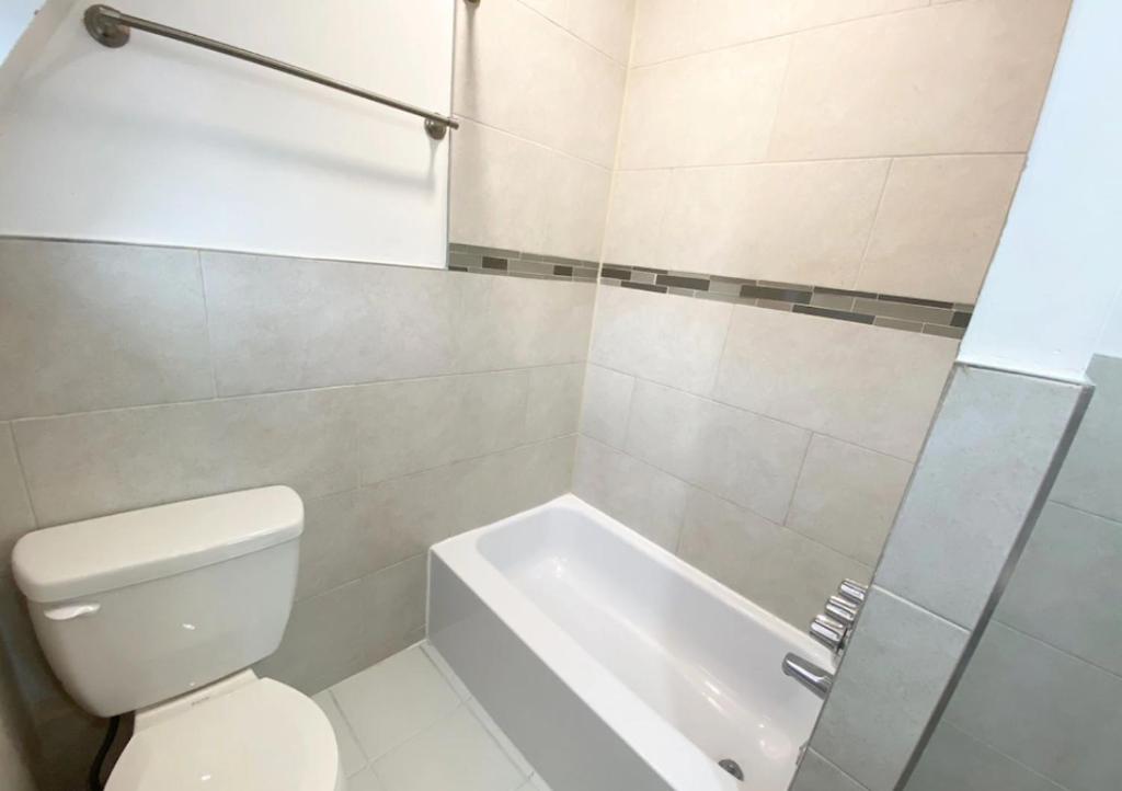 a bathroom with a toilet and a bath tub at Superb 1BR Apartment in NYC! in New York