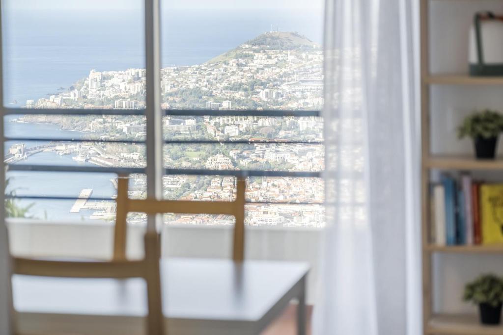 a room with a window with a view of a mountain at Casa da Angela in Funchal