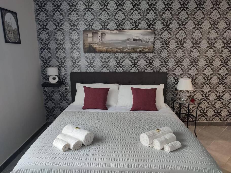 a bedroom with a bed with two towels on it at Vista sull'Eremo in Naples