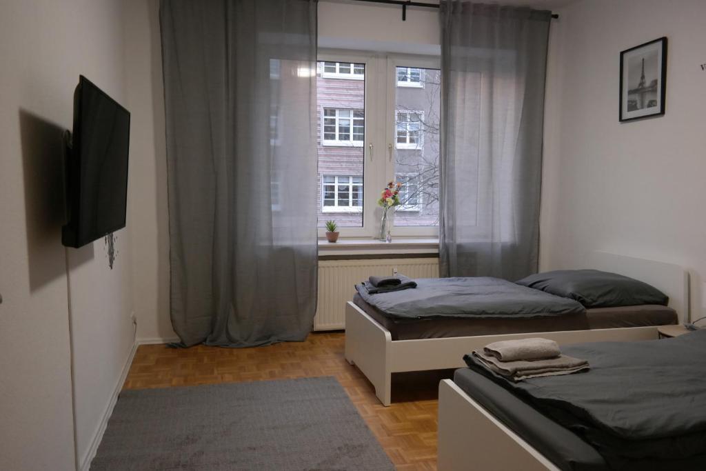 Кровать или кровати в номере Ruhrpott Apartment Zentral Smart