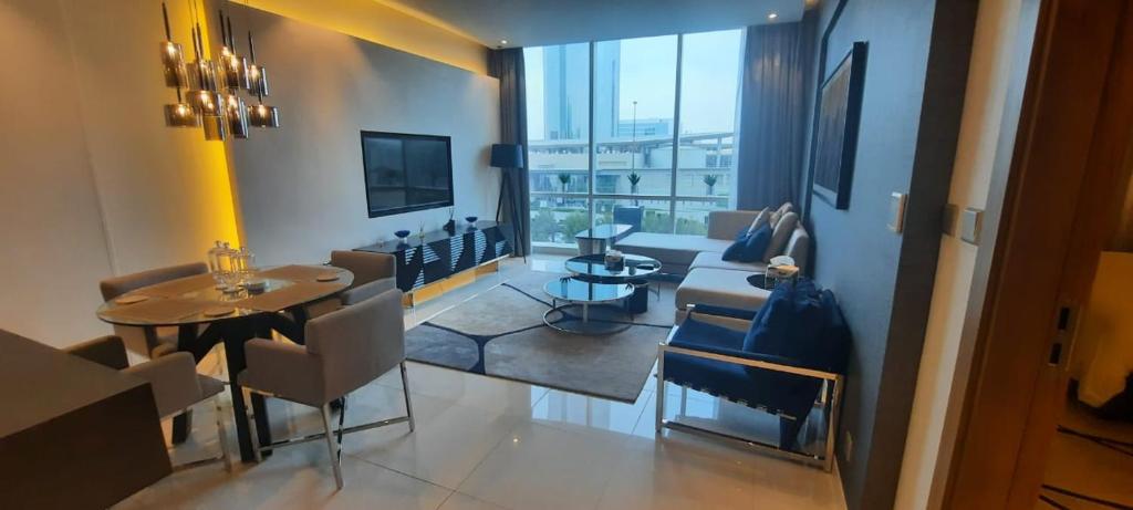 a living room with a table and chairs in a room at Luxury apartments - Damac tower in Riyadh