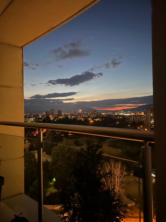 a view of a city at night from a balcony at Skyline Retreat Apartment at Sky Towers with Spa and Fitness Access in Skopje