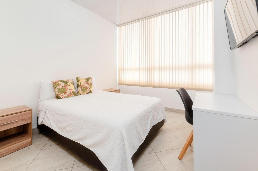 Postel nebo postele na pokoji v ubytování Hotel París