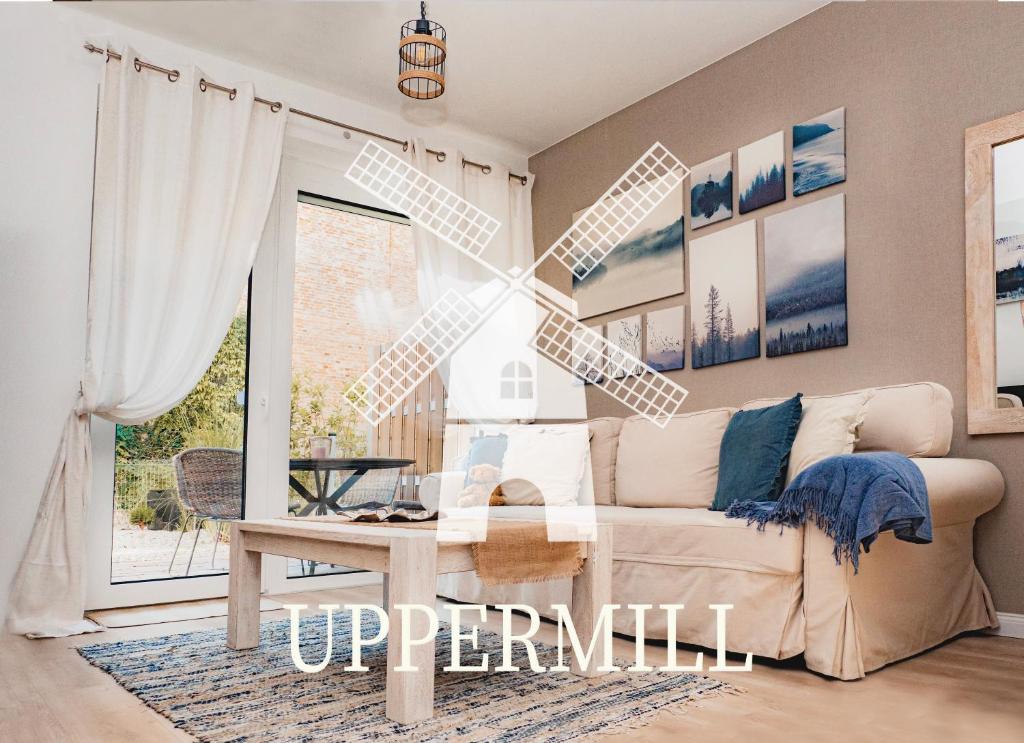 a living room with a couch and a table at Uppermill Suite #3 in Pécs