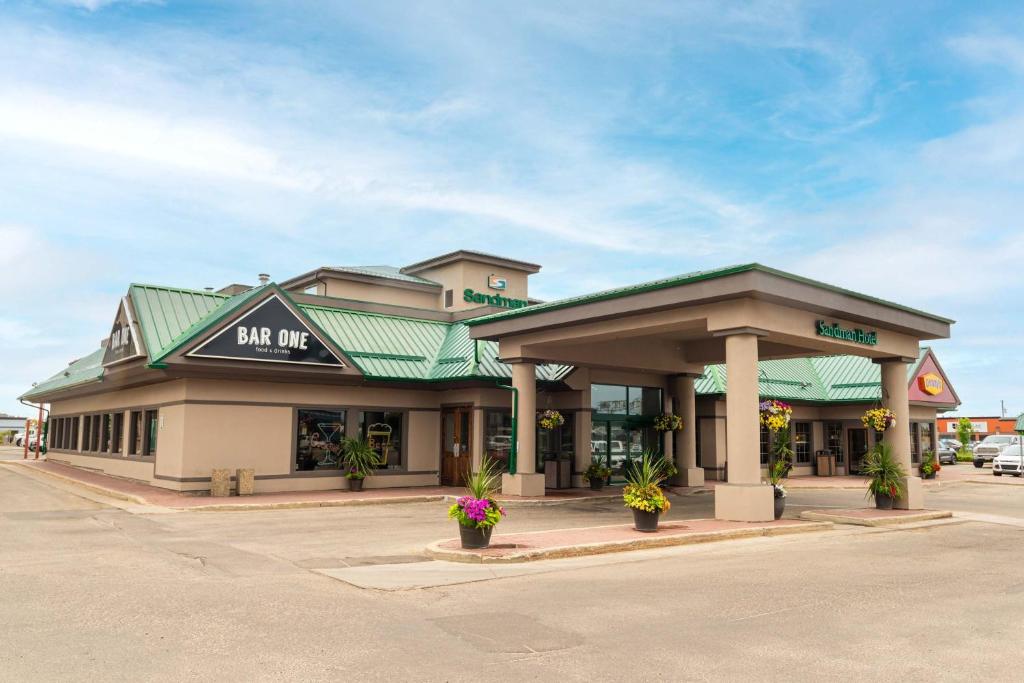 a building with a store on a street at Sandman Hotel Grande Prairie in Grande Prairie