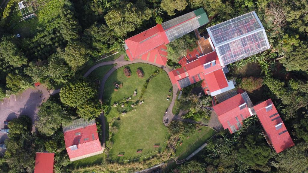 an overhead view of a house with a windmill at Valle Escondido Nature Reserve Hotel & Farm in Monteverde Costa Rica