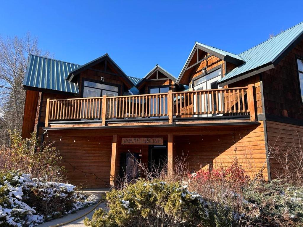 a large wooden house with a deck on it at Mountain Magic in Golden