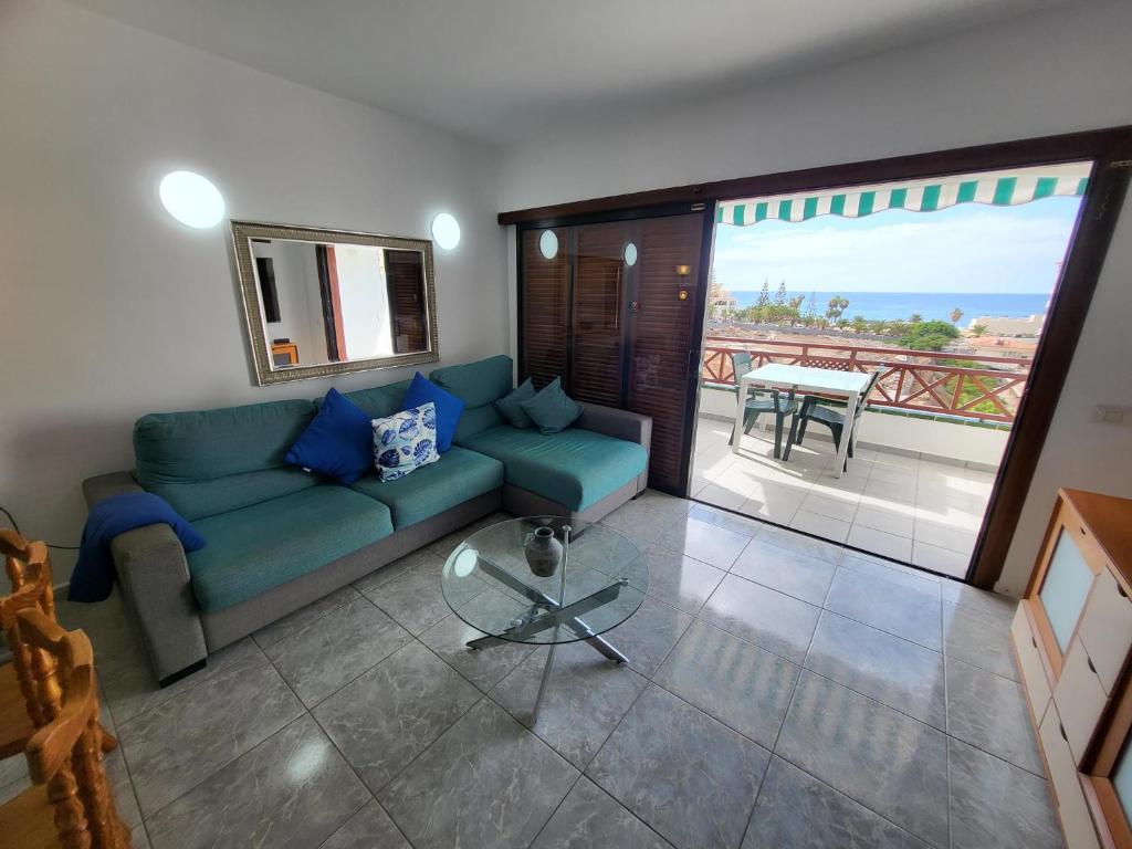 a living room with a couch and a glass table at Victoria Court II in Los Cristianos