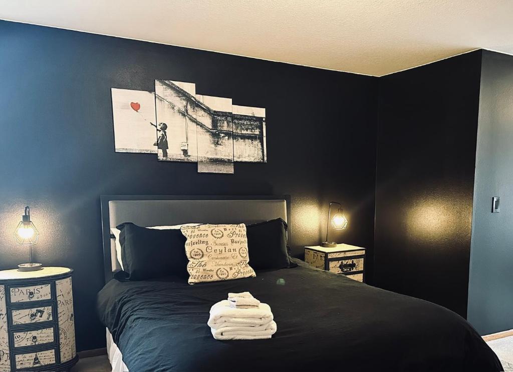 a bedroom with a bed with a black wall at Meritage in Corvallis