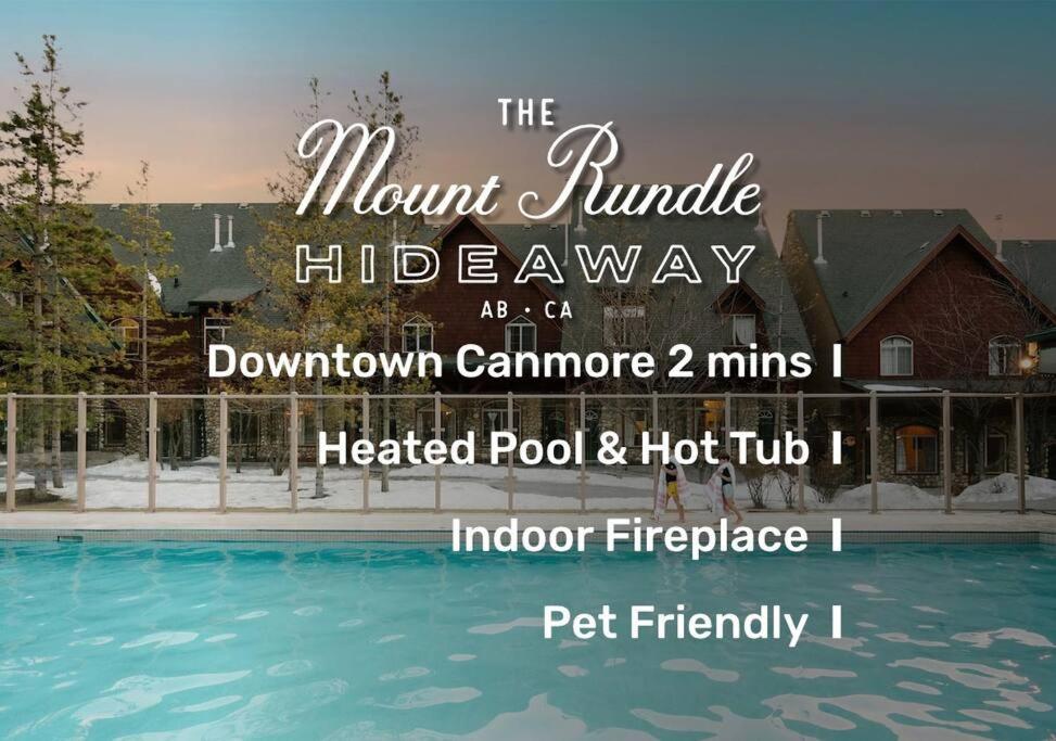 坎莫爾的住宿－Mount Rundle Hideaway with Heated Pool & Hot Tub and allows Pets，游泳池房屋标志