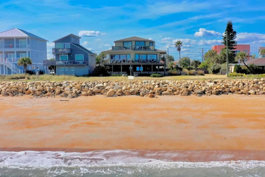 a flock of sheep standing on the beach at Chic Home: Ocean Views, Hot Tub & Game Room! in Flagler Beach