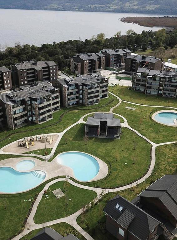 an aerial view of an apartment complex with two pools at Edificio Costa Pucón a pasos del Lago in Pucón