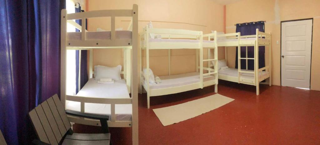 a room with three bunk beds in a room at Azzura Budget Rooms in Zamboanga