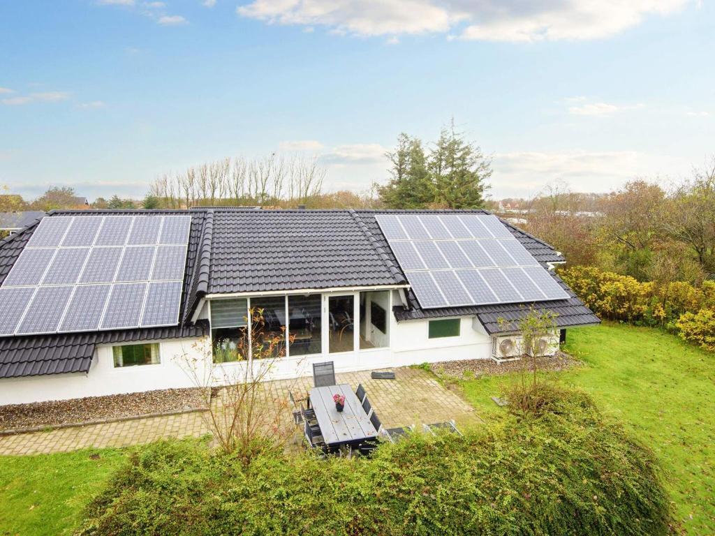a house with solar panels on the roof at Four-Bedroom Holiday home in Hemmet 14 in Falen