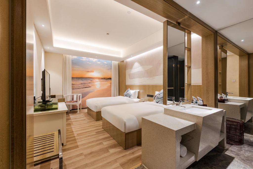 Postel nebo postele na pokoji v ubytování Paco Hotel Shuiyin Road Guangzhou-Free bus Canton Fair