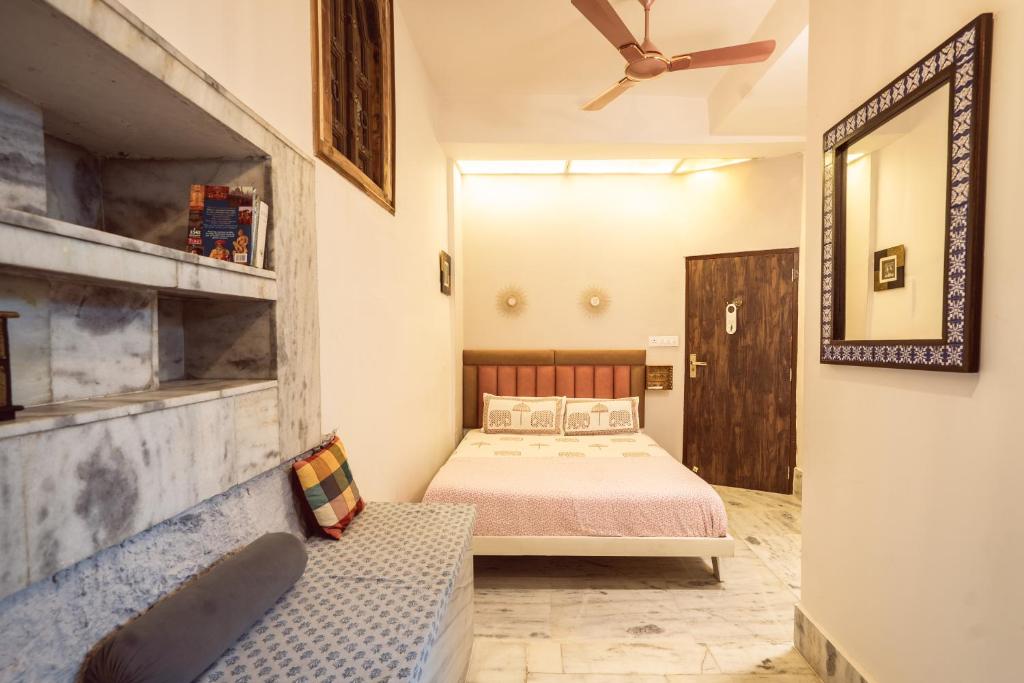 a bedroom with a bed and a mirror at Le Fort Homestay in Jaipur